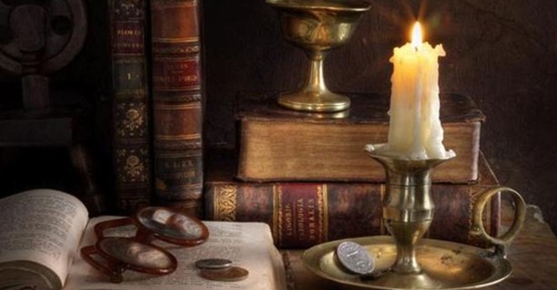 wisdom-lights-coins-books-candle-still-life